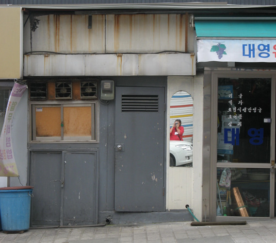 Self Portrait in storefront in Seoul